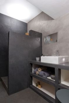 a bathroom with two sinks and black walls