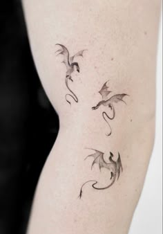 a woman's thigh with three dragon tattoos on it