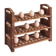 three tiered wooden rack with eggs on top and one egg in the middle, against a white background