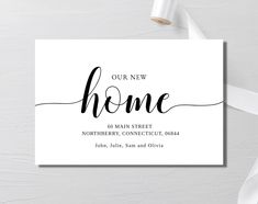 a white business card with the words home on it and a ribbon tied around it