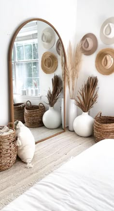 a bed room with a large mirror and baskets