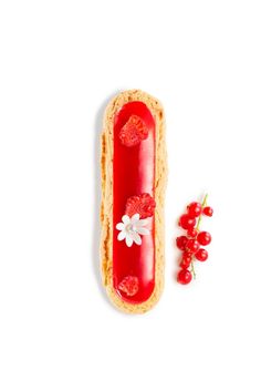 a piece of bread with red berries on it next to a cherry and flower decoration