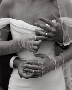 a woman in a wedding dress holding her hands together