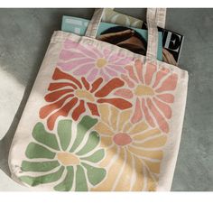 "Retro Floral Groovy Tote Bag, Hippie Mom bag, cute floral tote bag This 100% cotton bag comes in one size - 15\" x 16\"- perfect for everyday wear. While the canvas material will show off your designs in great colors, it's durable and will last for years. The bag features 20\" handles (made from the same canvas), making it easy to carry even with a week's worth of shopping. .: 100% cotton canvas .: Heavy fabric (12 oz/yd² (406.9 g/m .: Sewn-in label Due to my designs being specially made per order, I cannot accept returns unless there is a print error/manufacturing flaw" Canvas Tote Bag Painting Ideas Easy, Painting Tote Bags Aesthetic, Cute Painted Tote Bags, Paint Tote Bag Ideas Easy, Painting Canvas Bags, Cute Tote Bag Ideas, Flower Tote Bag Design, Painted Tote Bag Aesthetic, Tot Bag Design