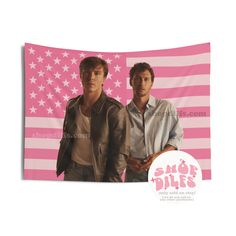 two men standing next to each other in front of an american flag wall hanging tapestry