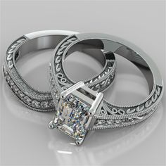 two wedding rings with a princess cut diamond in the center and filigree band