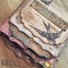 a stack of altered paper with the word discovery on it's cover and some birds