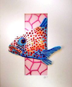 a painting of a fish on a white frame with pink and blue dots in the background