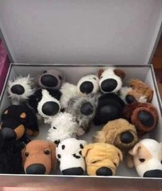 a box filled with lots of stuffed animals in it's sides and faces on top of each other