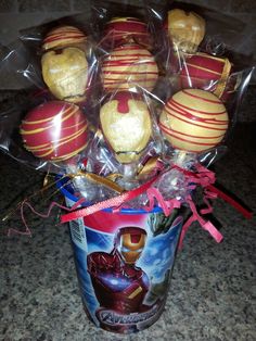 a bunch of apples wrapped in cellophane and tied to a can with ribbon