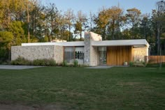 a house in the middle of a grassy field