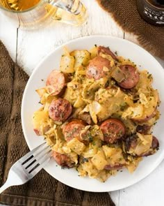 a white plate topped with pasta and sausage