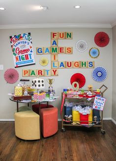 a party room with games and decorations on the wall