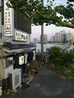 an alley way with buildings and water in the background