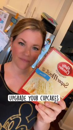 a woman holding up a box of cake mix in her hands with the words upgrade your cupcakes on it