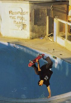 a man riding a skateboard up the side of a pool