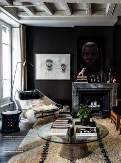 a living room filled with furniture and a fire place next to a painting on the wall