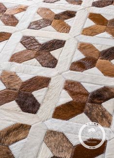 a brown and white patchwork quilt on the ground