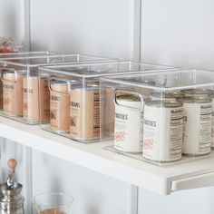 the shelves are filled with jars and spices