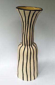 a black and white striped vase sitting on top of a table