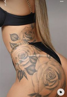 the back of a woman's stomach with roses tattooed on her chest and bottom