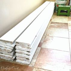 several pieces of wood stacked on top of each other in a room with tile flooring