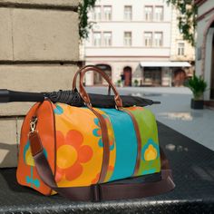 "Retro Flower Power, Mod Daisy, Scandinavian Flowers, Orange, Green, Teal Hippie, Hipster Mid Mod Waterproof Travel Bag. This personalized travel bag is all about style. Made with high-grade waterproof fabric, it's a highly durable means of transferring your essentials wherever you go. With multiple compartments, a resilient carrying handle, and an adjustable shoulder strap, it's the perfect companion for all your adventures. It's about time to hit the road. Travel in style. This bag also makes Colorful Retro Travel Bags, Multicolor Flower Shaped Shoulder Bag For Travel, Retro Floral Print Bags For Everyday Use, Retro Yellow Travel Bag, Retro Multicolor Bags With Zipper Pocket, Scandinavian Flowers, Pictures Friends, Flower Power Hippie, Personalized Travel Bag