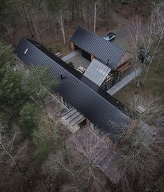 an aerial view of a house in the woods