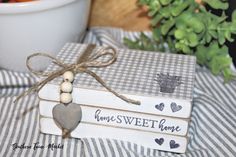 a bowl of carrots sitting on top of a table next to two wooden signs