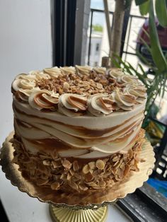 there is a cake that has been decorated with nuts and icing on the top