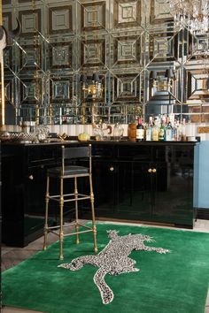 an animal rug in the middle of a room with mirrors on the wall and stools