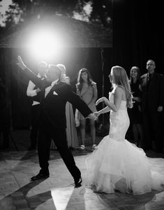 the bride and groom are dancing on the dance floor