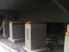 cement blocks are stacked up in an unfinished room