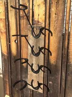 a wooden fence with wrought iron designs on it