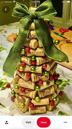 a christmas tree made out of wine corks with a green bow on the top