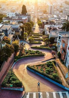 an aerial view of a city with lots of buildings and gardens in the middle of it