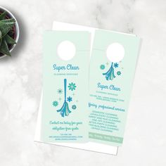 two door hangers with snowflakes on them next to a potted plant