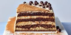 a large piece of cake sitting on top of a white plate with chocolate candies