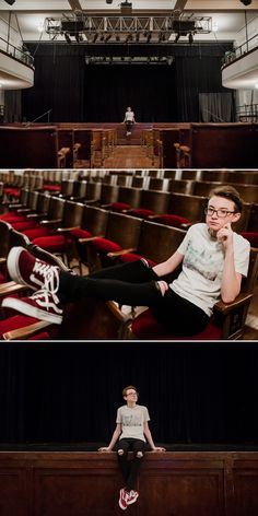 two people sitting on chairs in front of an auditorium