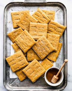 crackers and honey on a baking sheet