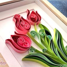 some paper flowers are sitting in a box