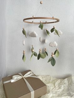 a gift box and a wind chime hanging from the ceiling with leaves on it