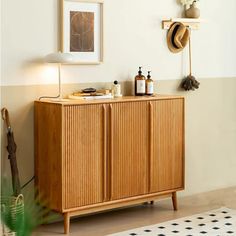 a wooden cabinet sitting in the corner of a room with hats on top of it