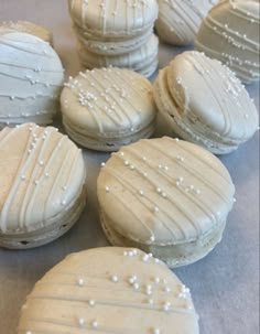 some white frosted cookies sitting on top of a table