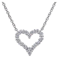 Tiffany & Co. Platinum and Diamond Heart Pendant Necklace The perfect little heart necklace for layering or worn by itself. .25 Carats of fine quality round brilliant cut diamonds set in platinum. Chain length: 16' Heart Dimensions: 11mm H x 11.60mm W Diamond Pendant Necklace Tiffany & Co., Diamond Necklace Pendant Tiffany & Co., Diamond Heart Necklace Tiffany & Co., Luxury Classic Heart Solitaire Necklace, Luxury Heart Cut Brilliant Solitaire Necklace, Tiffany&co Necklace, Diamond Pendant Tiffany & Co., Heart-shaped Cubic Zirconia Necklace With Prong Setting, Fine Jewelry Heart Pendant Necklace With Prong Setting