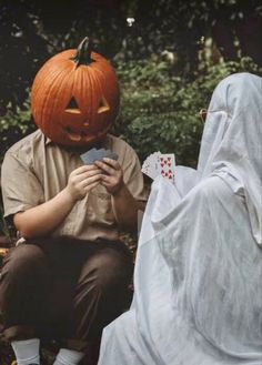 two people dressed up as ghost and pumpkins