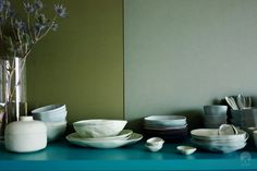 a table topped with plates and vases filled with flowers