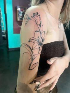 a woman with a flower tattoo on her arm