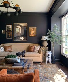 a living room filled with furniture and pictures on the wall above it's coffee table