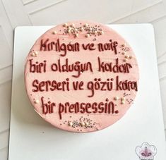 a pink cake with words written on it